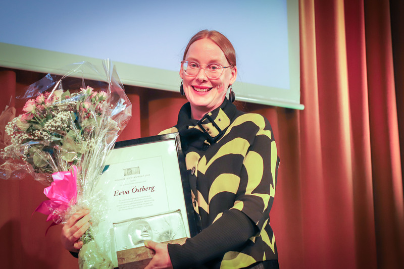 Eeva Österberg tar emot minoritetsspråkspriset på scen. Foto: Karin Skoglund.